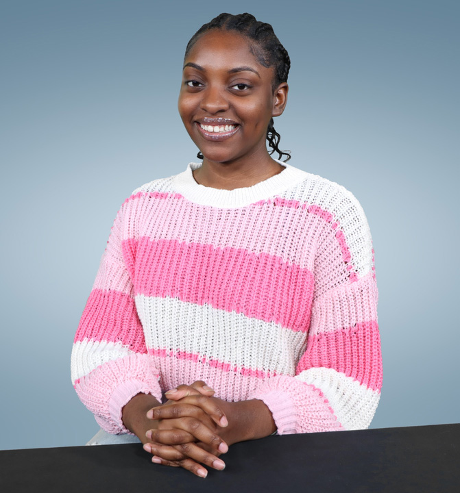 Kayla Williams smiling in striped shirt for picture