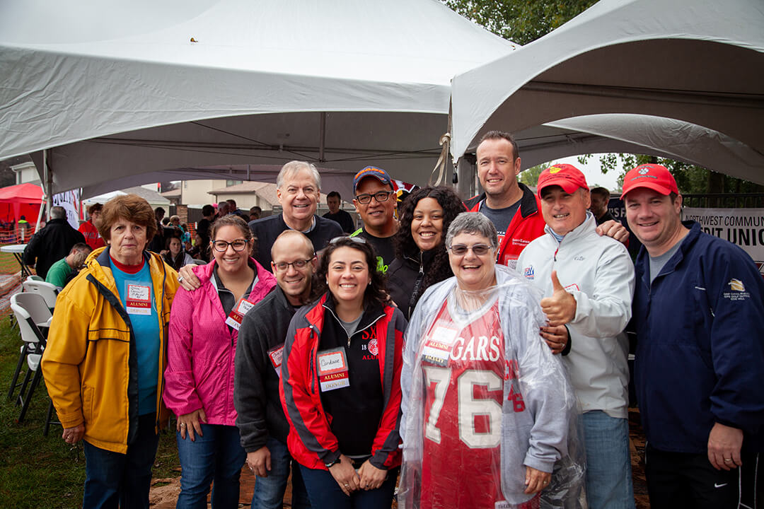 Group of SXU alumns at a homecoming tent