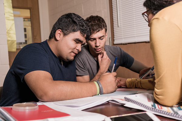 A group of students working at their desks on a project