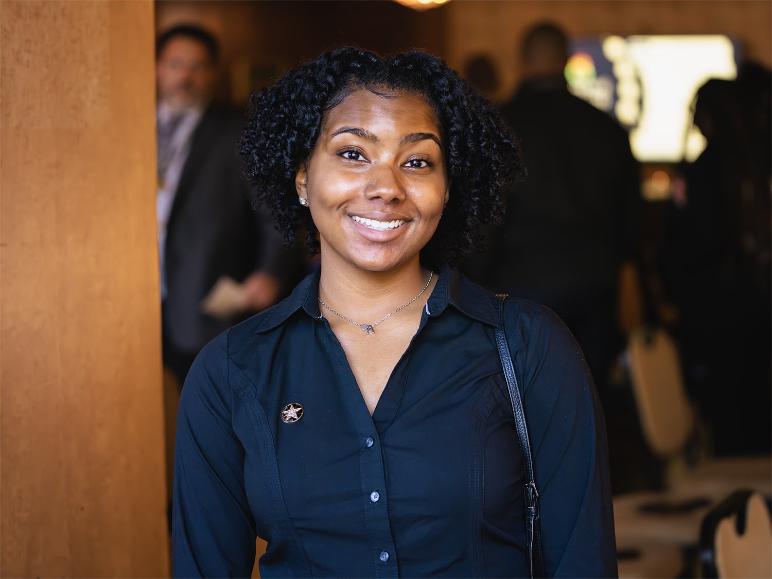 Girl in business atire smiling for a picture