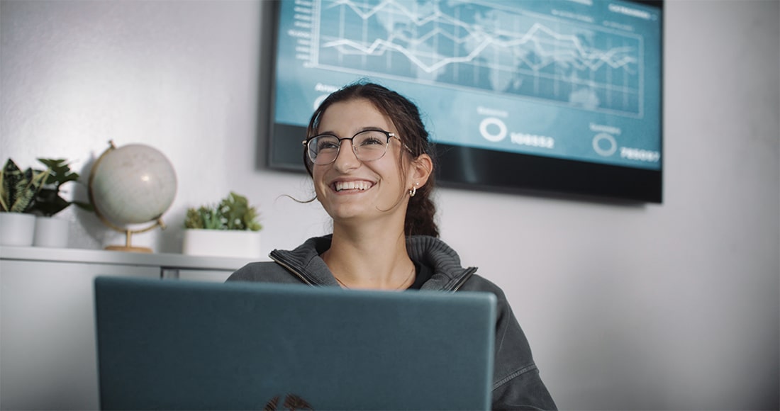 Girl smiling at laptop in class