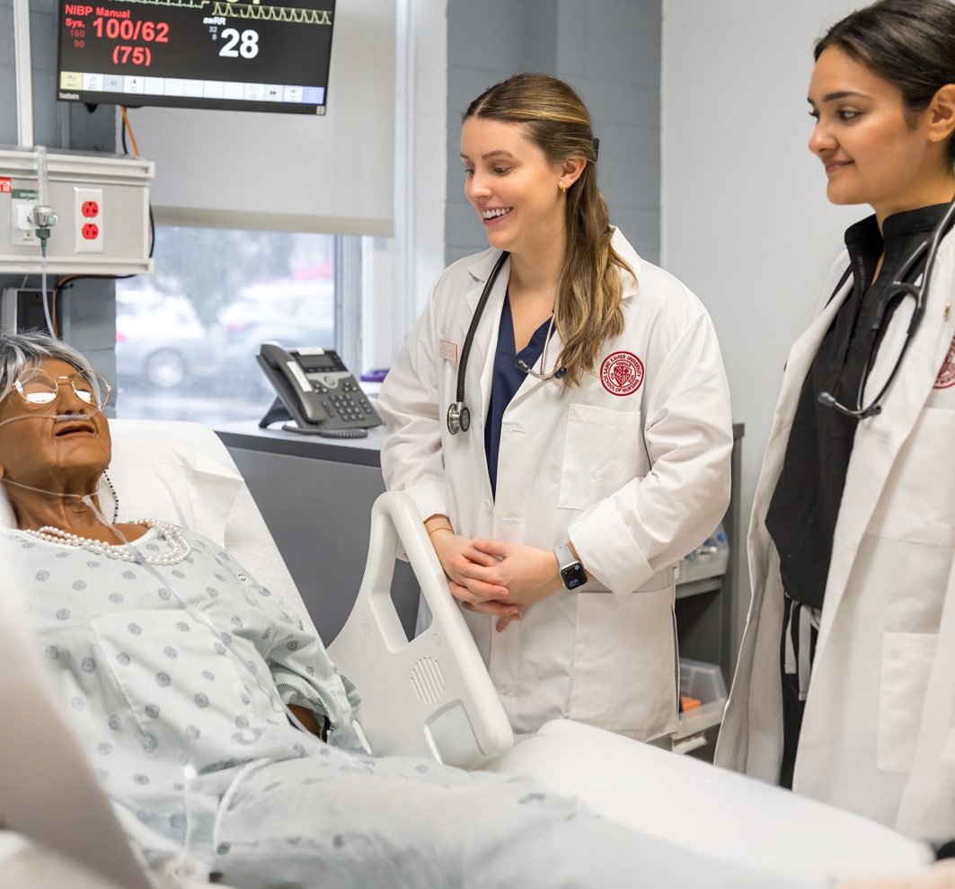 Nursing students working on model patient