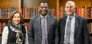 President Elder standing with members of Brother Rice and Mother McCauley